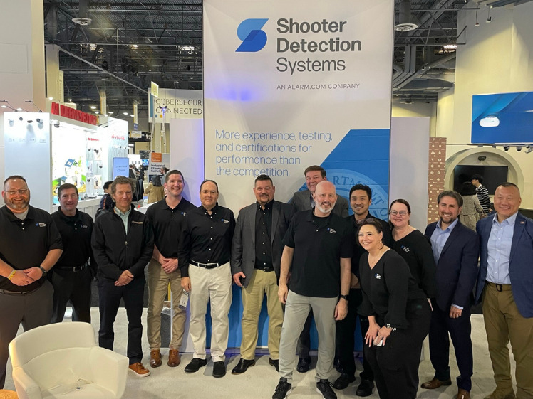 Group photo in front of Shooter Detection Systems sign
